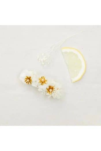 Gold metal flowers clip adorned with a pearl