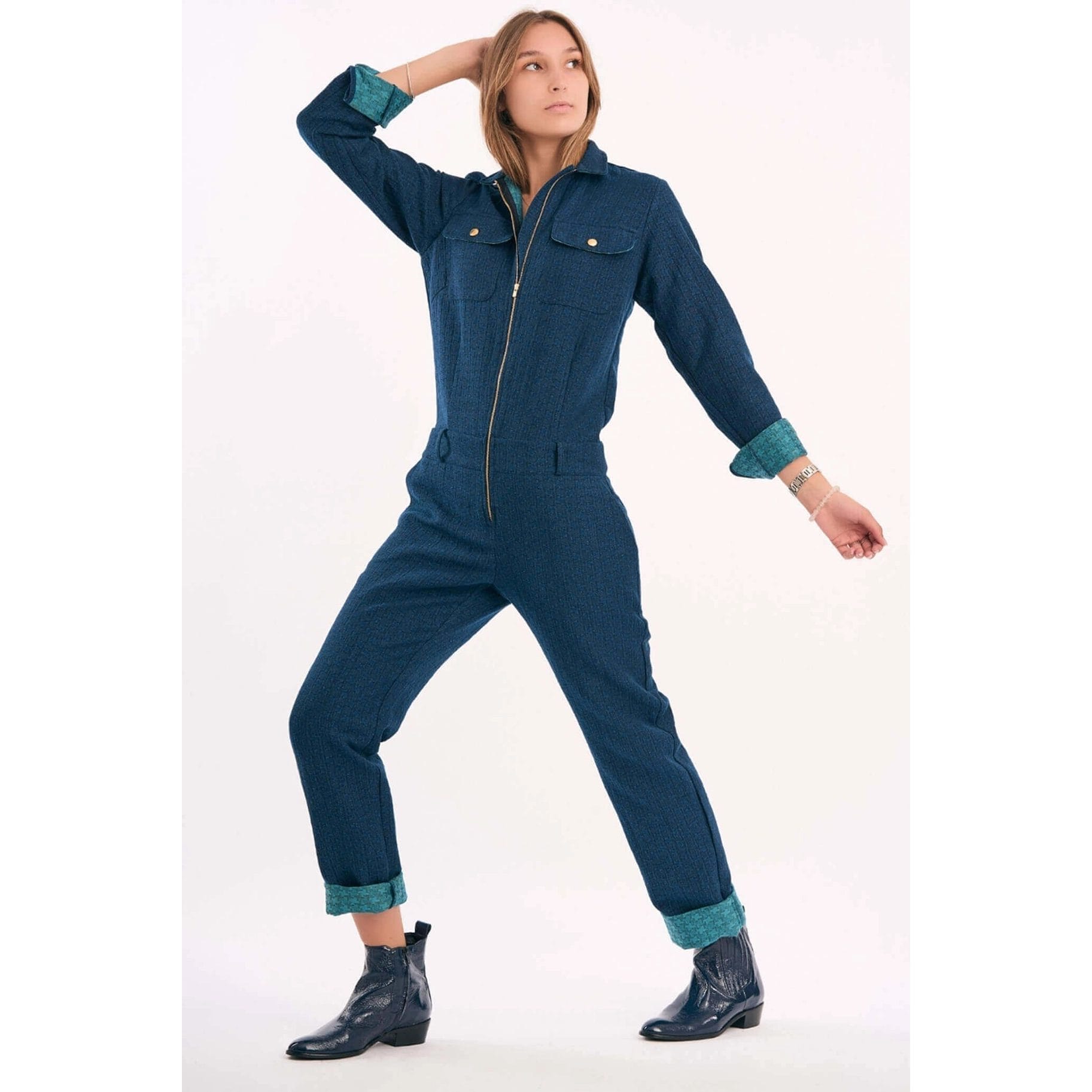 - Denim jumpsuit with a golden zip closure